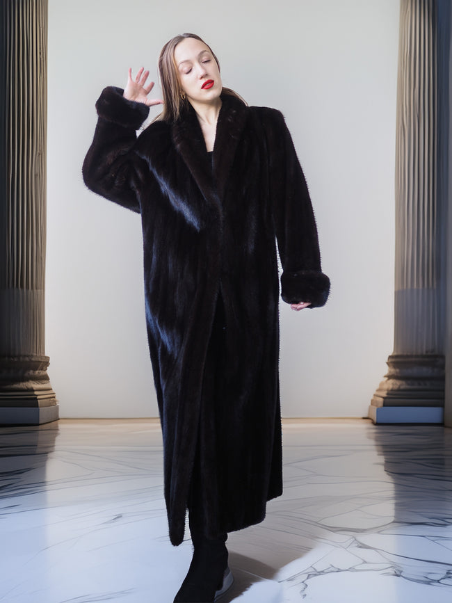 Woman wearing a black fur coat in an elegant interior setting