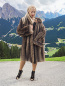 a woman in a fur coat posing for a picture