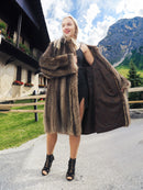 a woman in a fur coat posing for a picture