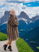 a woman in a fur coat standing on a path