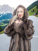 a woman in a fur coat standing on a road