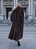 Model displaying inner lining of mink fur coat