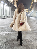 Beige Mink Fur Coat - Vintage Luxury shown from back in motion. Timeless fur coat for elegant winter wardrobes.