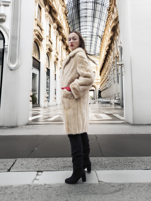 Vintage Beige Pearl Mink Fur Coat S/M side view in architectural setting. Elegant outerwear for luxury winter fashion.
