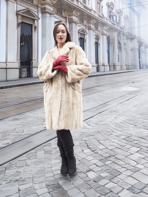 Beige Mink Fur Coat - Vintage Luxury in front of historic building. Medium size fur coat for timeless winter elegance.