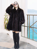 Black Mink Swing Coat - Riviera Noir styled among ancient ruins by the sea. Elegant fur coat for timeless winter fashion.