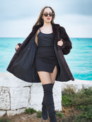 Black Mink Swing Coat - Riviera Noir open to reveal a sleek black dress. Luxurious fur outerwear for elegant winter outfits.