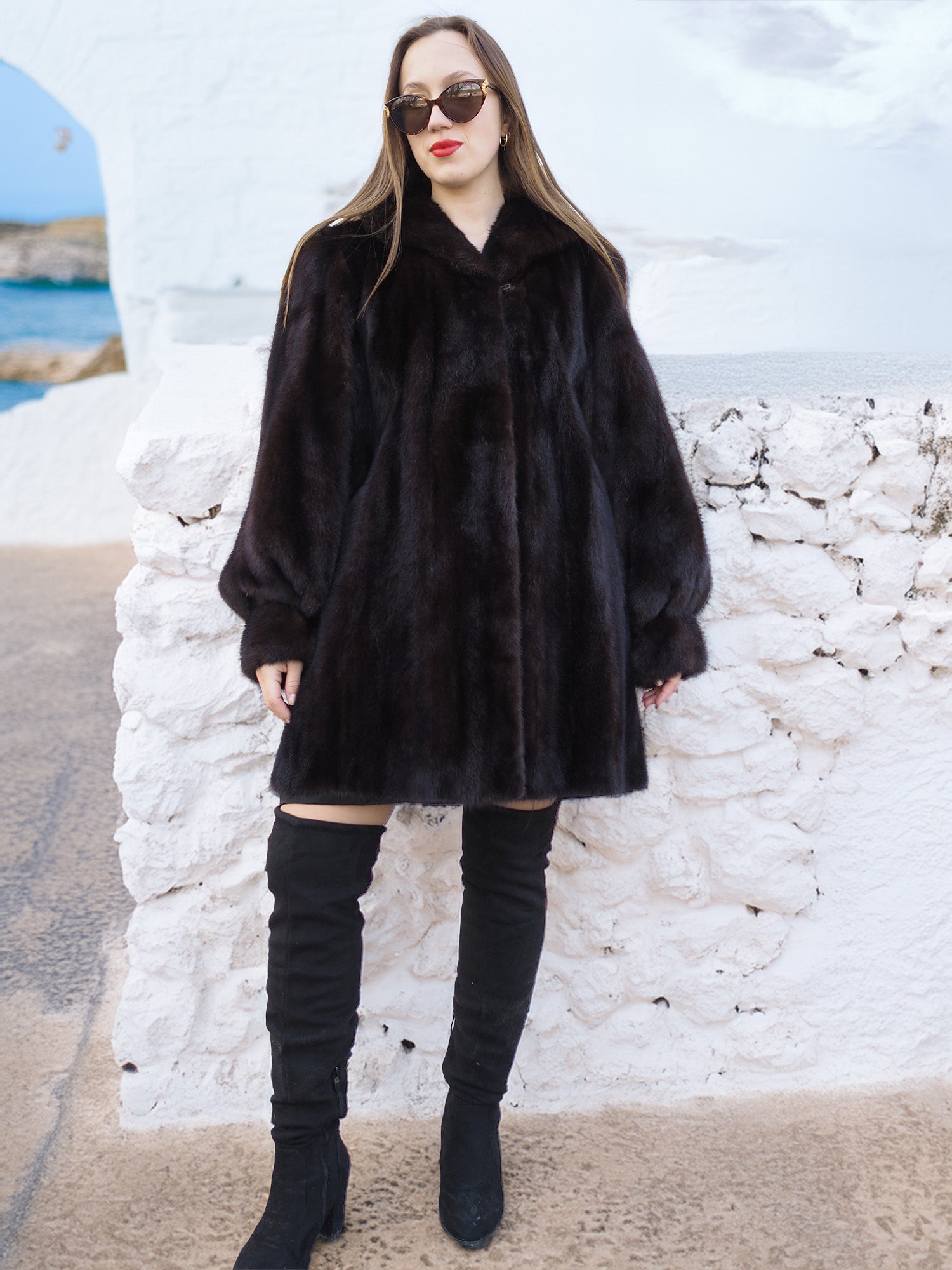 Authentic Black Mink Swing Coat - Riviera Noir worn with sunglasses and boots. A statement fur jacket for cold-weather elegance.