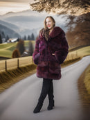Woman in a purple fur coat standing on a snowy road with a scenic background