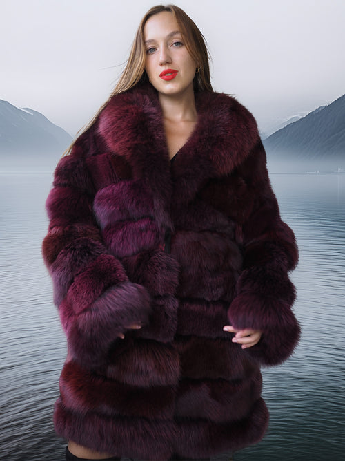 Woman wearing a fur coat with a mountainous landscape in the background