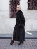 Chic black mink fur coat, classic and elegant silhouette, complemented by fashionable heels for a sophisticated urban look.