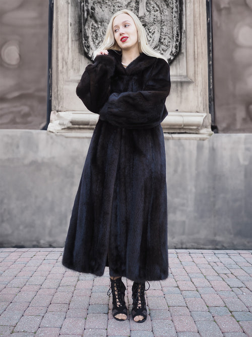 Elegant black mink fur coat worn by female model, showcasing premium Canadian craftsmanship and style.