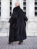 Luxurious black mink fur coat on display, highlighting its plush texture and sleek design.