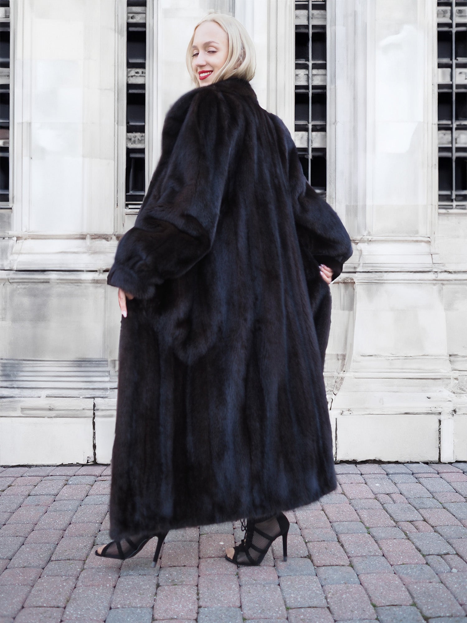 Luxurious black mink fur coat on display, highlighting its plush texture and sleek design.