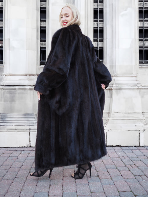 Luxurious black mink fur coat on display, highlighting its plush texture and sleek design.