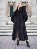 Elegant black mink fur coat on display, showcasing luxurious fashion accessory for stylish women.