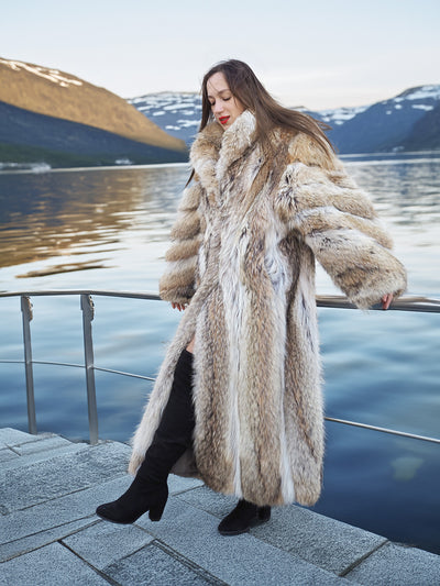 Vintage Coyote Fur Coat with bold fur pattern and collar, styled beside a calm lake with mountain reflections.