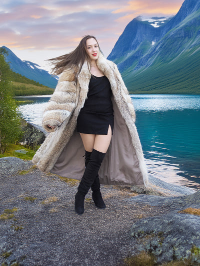 Coyote Fur Coat 50" Long, worn open over a black mini dress, styled in a scenic mountain setting at sunset.