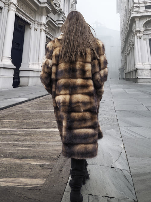 Back view of long fur coat with horizontal striped pattern and full sleeves
