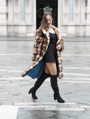 Fur coat with horizontal striped design, button front and stand-up collar