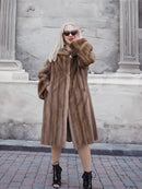 Stylish pastel brown mink fur coat on model against stone building
