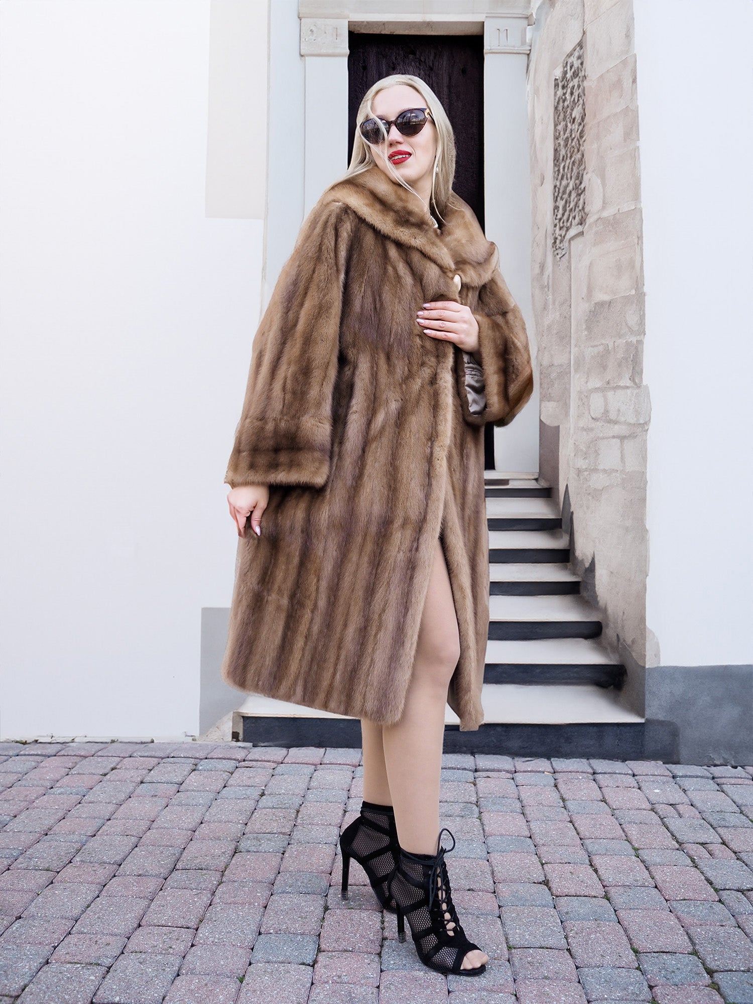Elegant vintage-style Canadian mink fur coat, worn by fashionable woman standing on steps.