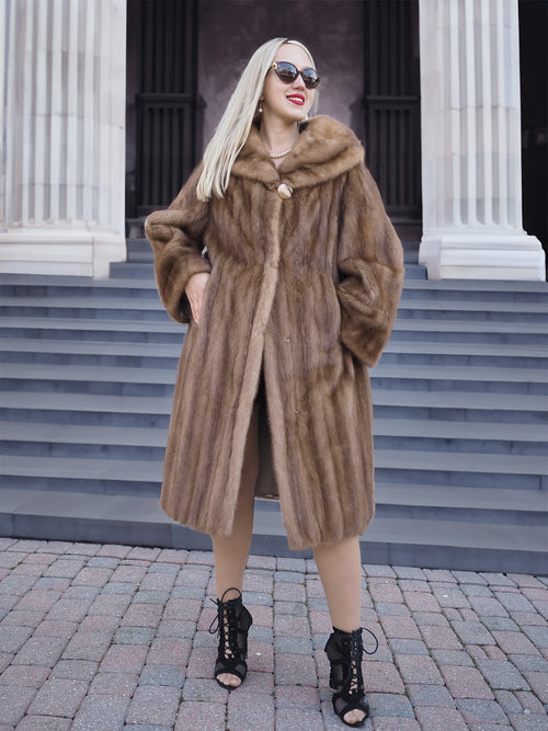 Luxurious Canadian brown mink fur coat with oversized hood, displayed on marble columns.