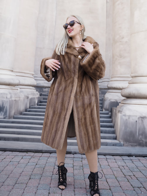 Elegant vintage Canadian brown mink fur coat with plush collar, worn by stylish woman with sunglasses outside stately building.