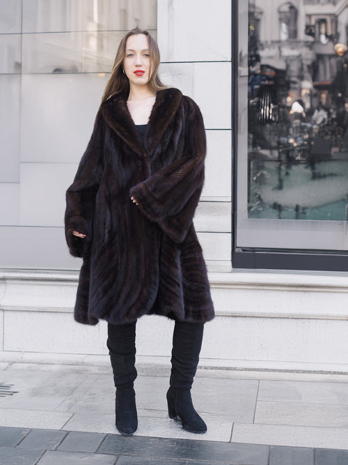 Model wearing XL/XXL mahogany mink swing coat with flared sleeves and soft sheen. Luxury fur outerwear for cold-weather sophistication.