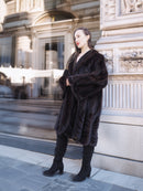 Side profile of model in XL/XXL mahogany mink coat with soft texture and wide sleeves. Chic fur outerwear for cold-weather elegance.