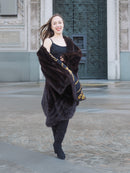 Model twirling in mahogany mink swing coat XL/XXL revealing ornate gold baroque lining. Elegant and playful luxury fur fashion.