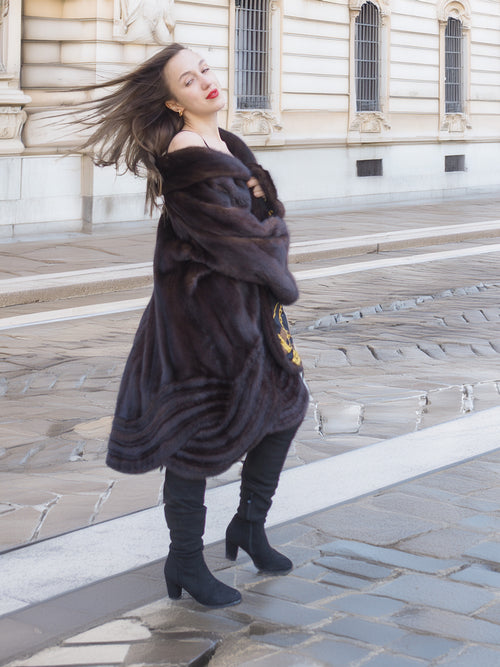 Model twirling in XL/XXL mahogany mink coat with gold baroque lining visible. Elegant fur outerwear for winter fashion enthusiasts.