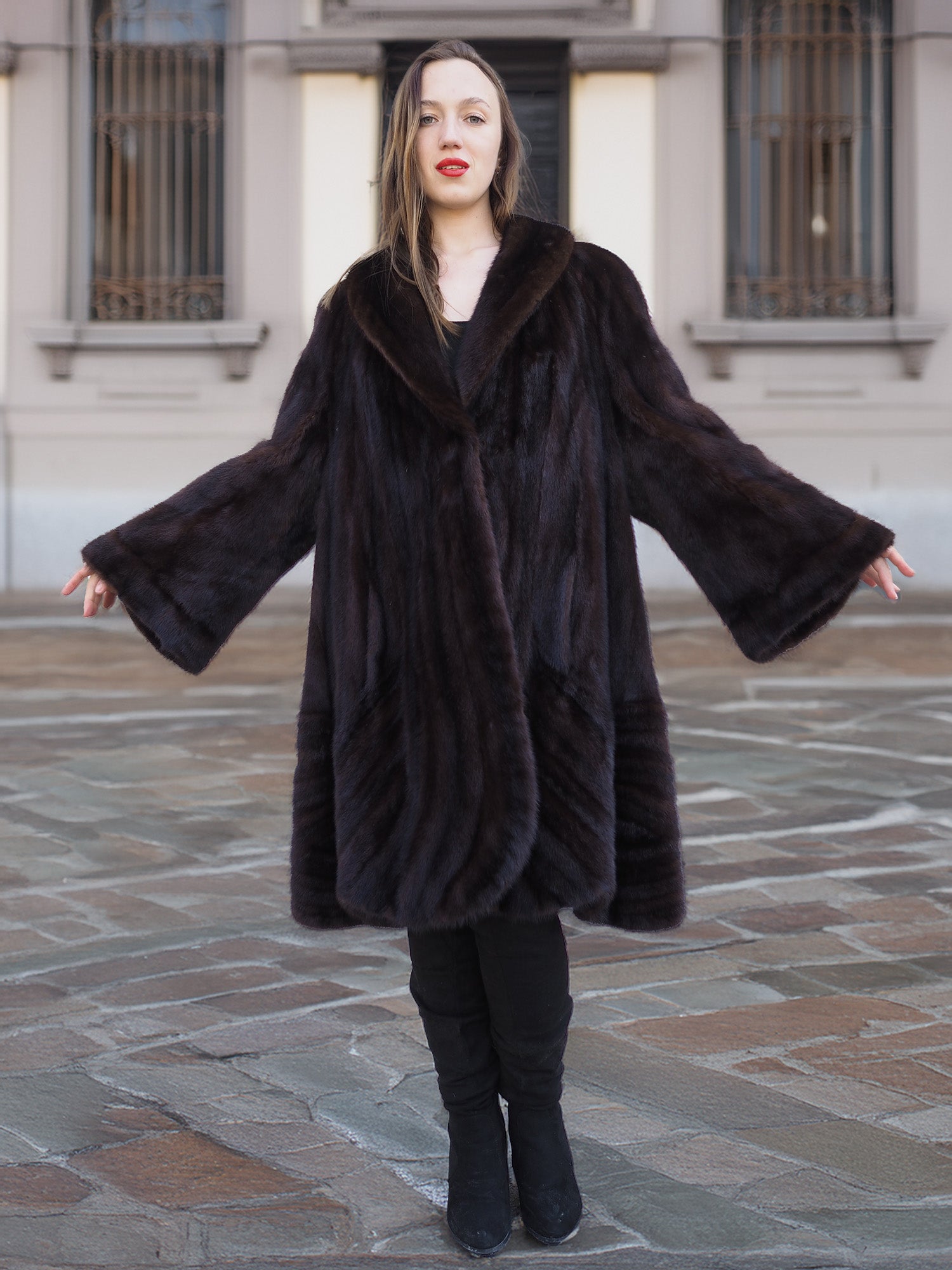 Arms extended to show bell sleeves of mahogany mink swing coat XL/XXL. Luxe fur outerwear with gold baroque lining detail.