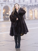 Elegant woman in mahogany mink swing coat XL/XXL with baroque lining detail. Warm and stylish real fur coat for winter fashion.