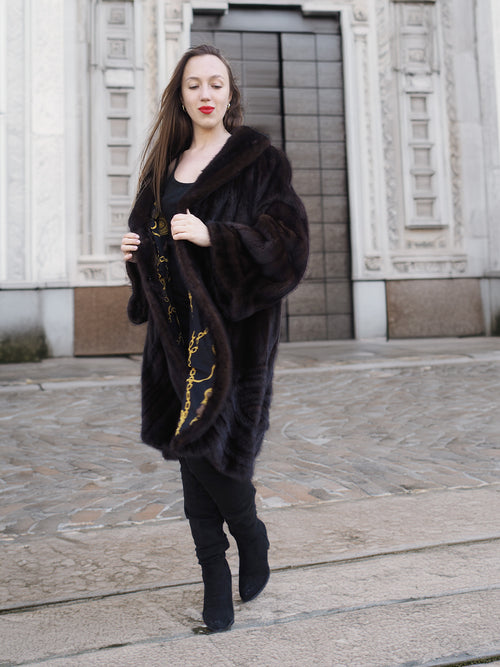 Model walking in XL/XXL mahogany mink swing coat with gold baroque lining. Real fur outerwear for stylish winter elegance.