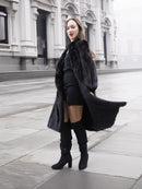 Stylish black mink fur coat paired with thigh-high boots, perfect for chic winter fashion and luxury outerwear.