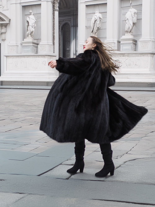 Dark ranch mink fur coat twirling in motion, emphasizing the coat’s full volume and soft, lustrous texture.