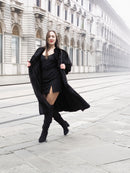 Model in black mink fur coat walking confidently, highlighting the coat’s elegant flow and premium craftsmanship.