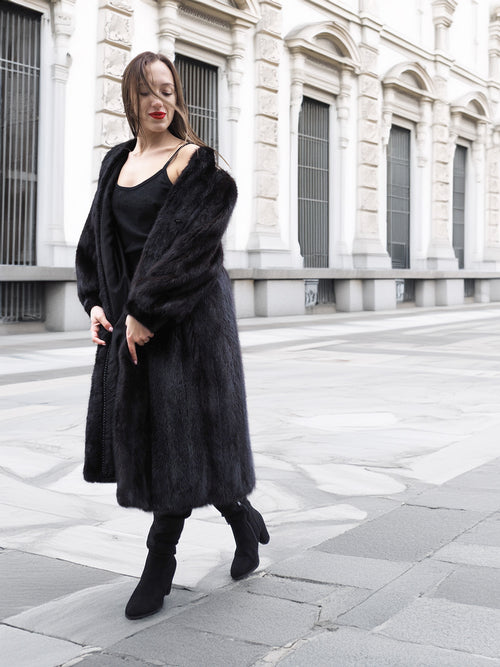 Dark ranch mink fur coat worn open over a black outfit, styled for modern luxury and cold-weather fashion.