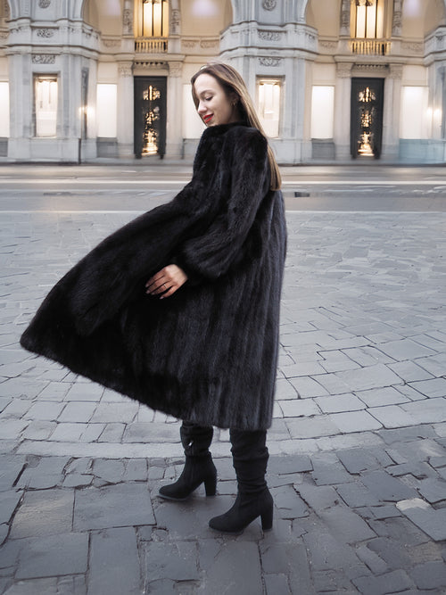 Dark ranch black mink fur coat with voluminous silhouette and rich texture, styled for upscale winter fashion.