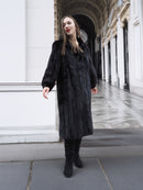Dark ranch black mink fur coat with structured silhouette and soft texture, styled for elegant winter fashion.