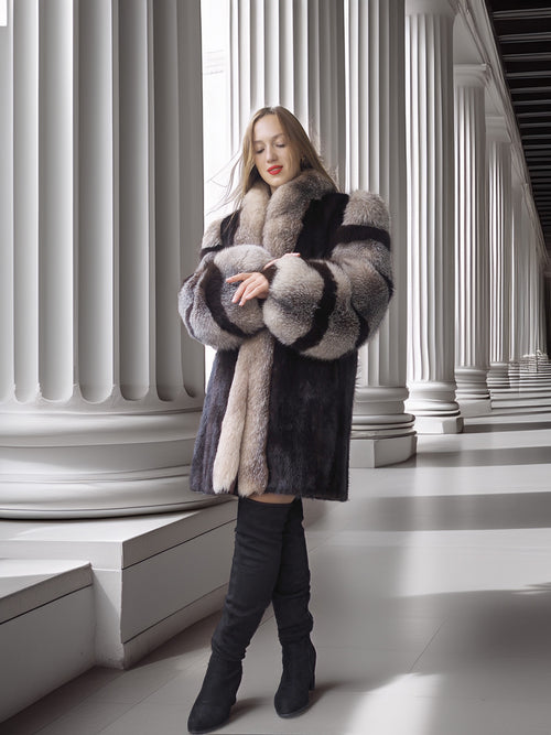 Woman wearing a patterned fur coat in a classical architecture setting