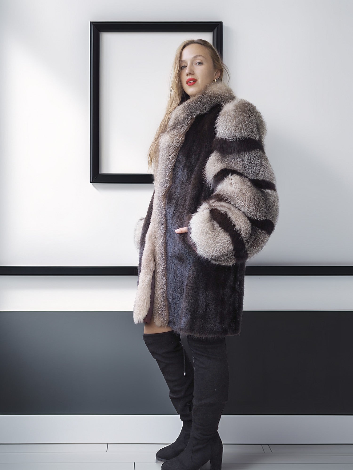 Woman wearing a fur coat with a striped pattern in a minimalistic setting.