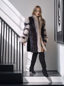 Woman wearing a fur coat standing on a staircase with a modern interior background