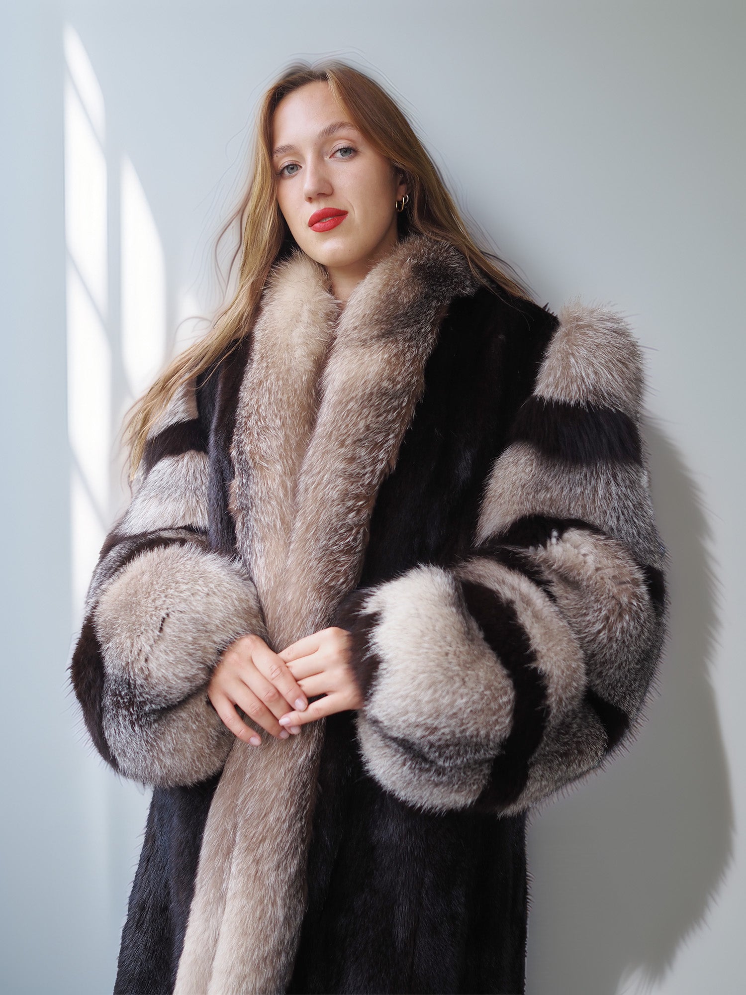 Woman wearing a fur coat with a neutral background