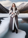 Woman in a fur coat standing on a snowy landscape with mountains in the background