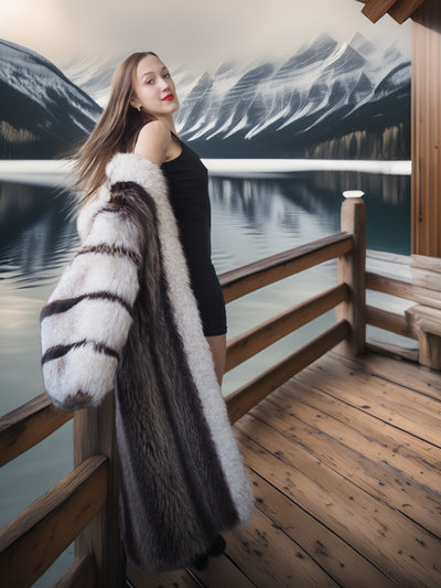 Woman in a fur coat standing on a wooden deck with a mountain and lake background
