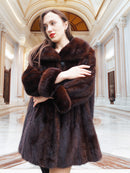 Model crossing arms in vintage mink coat, showcasing plush fur and timeless elegance in a marble hall.
