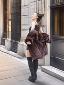 Vintage mink fur coat worn open, revealing satin lining and capturing timeless elegance in winter fashion.