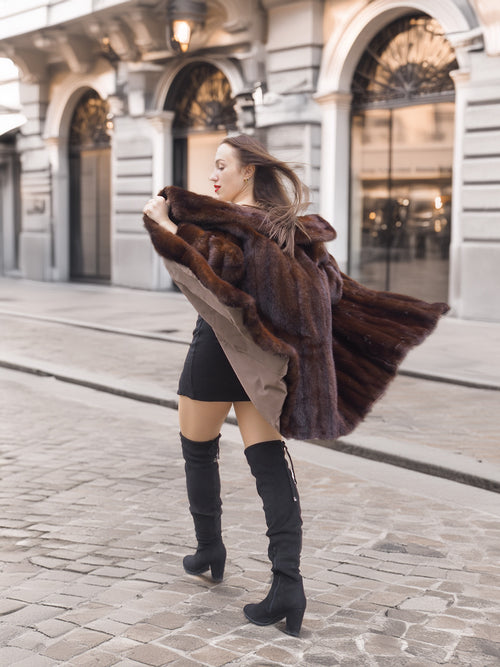 Full-length mahogany mink coat in motion, highlighting its voluminous silhouette and natural fur sheen for luxury outerwear.